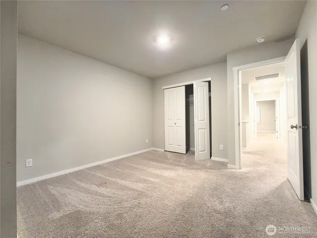 a view of an empty room and a window