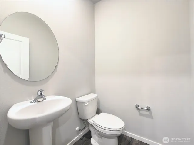 a bathroom with a sink a mirror and a toilet