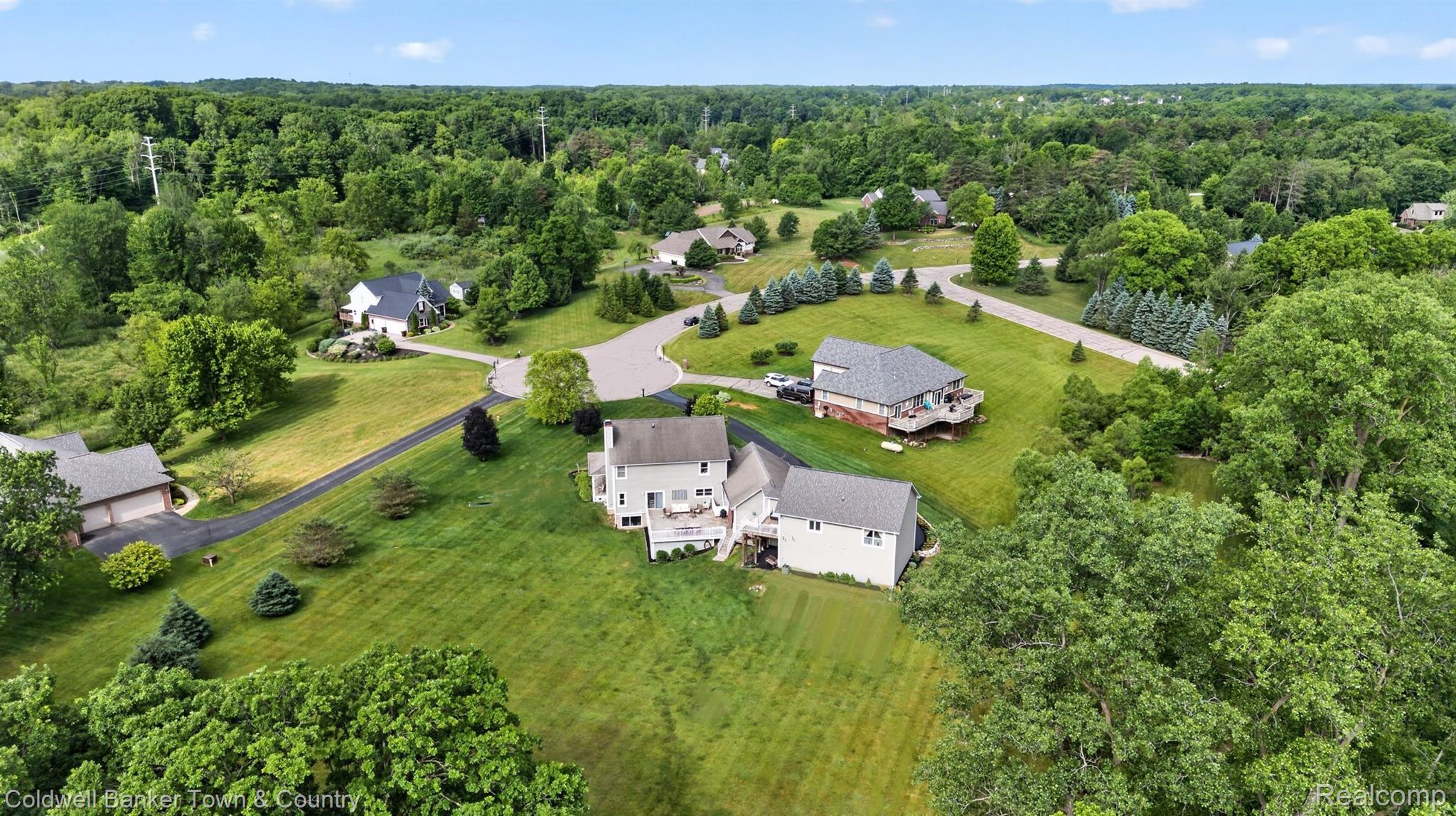 918 Gray Fox Court Howell, MI 48843 - Photo 72 of 84 Aerial perspective showcasing a residential community surrounded by abundant mature trees and natural landscaping