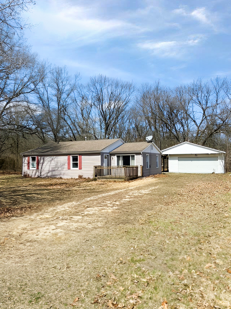 13269 East Spinning Wheel Road Pembroke Township, IL 60958 - Photo 1 of 15 a front view of a house with a garden and mountain view