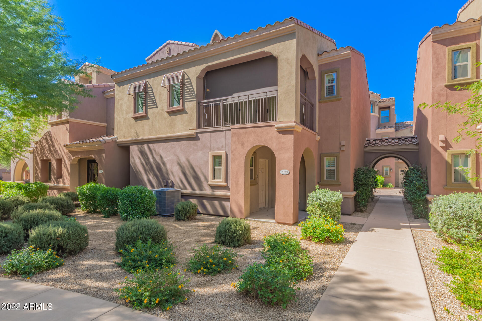 3935 East Rough Rider Road, Unit 1369 Phoenix, AZ 85050 - Photo 2 of 44 a front view of a multi story residential apartment building