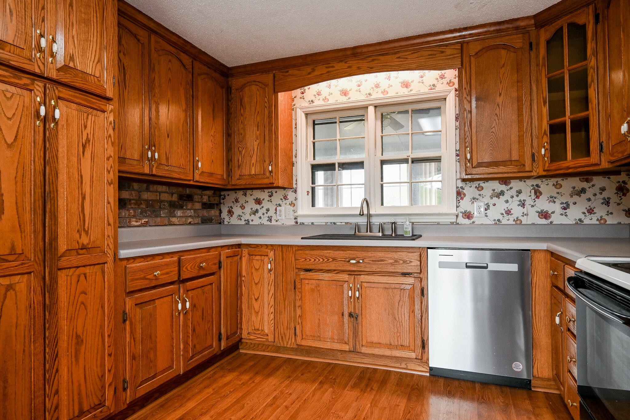 2464 No Pone Road Northwest Georgetown, TN 37336 - Photo 12 of 50 a kitchen with stainless steel appliances granite countertop wooden cabinets a sink and dishwasher with wooden floor
