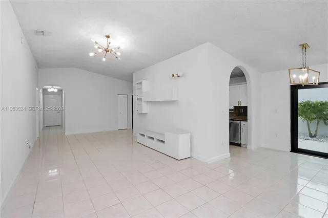 a large kitchen with stainless steel appliances granite countertop a stove a sink and a granite counter tops