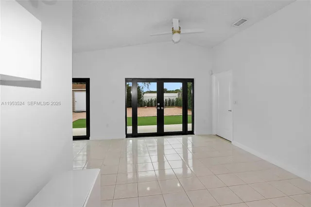a view of room with a ceiling fan and wooden floor