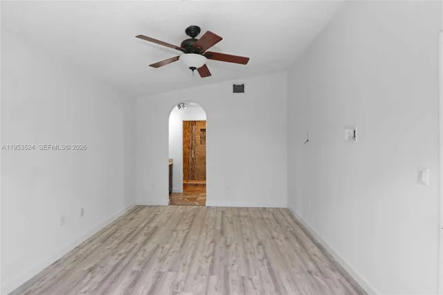 an empty room with closet and wooden floor