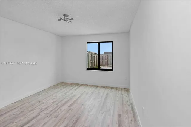 a view of an empty room with a ceiling fan