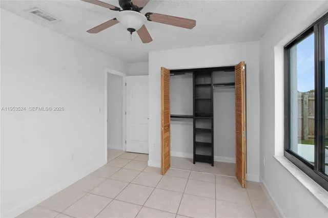 a view of a backyard with a garden and entertaining space