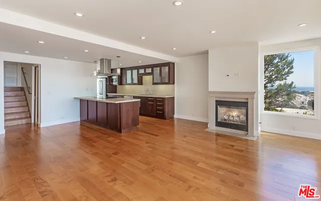 a view of kitchen and kitchen with furniture wooden floor and window