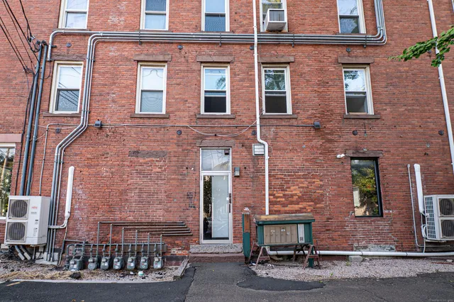 front view of a brick house with a small yard