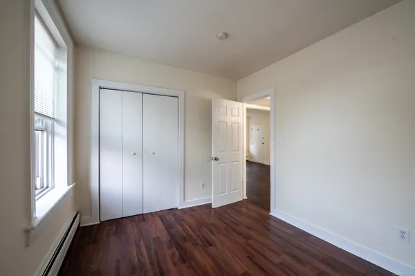 a view of wooden floor and windows in a room