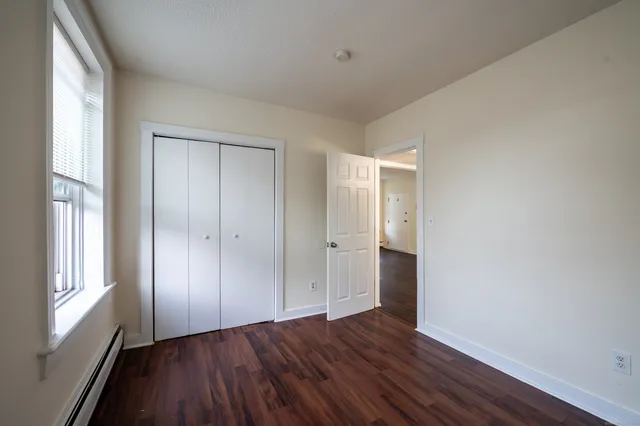 a view of wooden floor and windows in a room