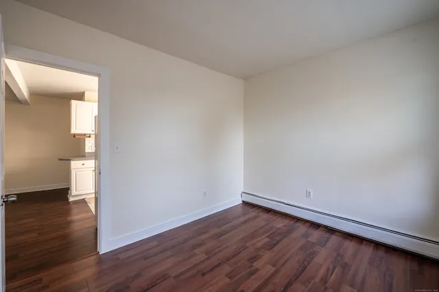a view of a room with wooden floor