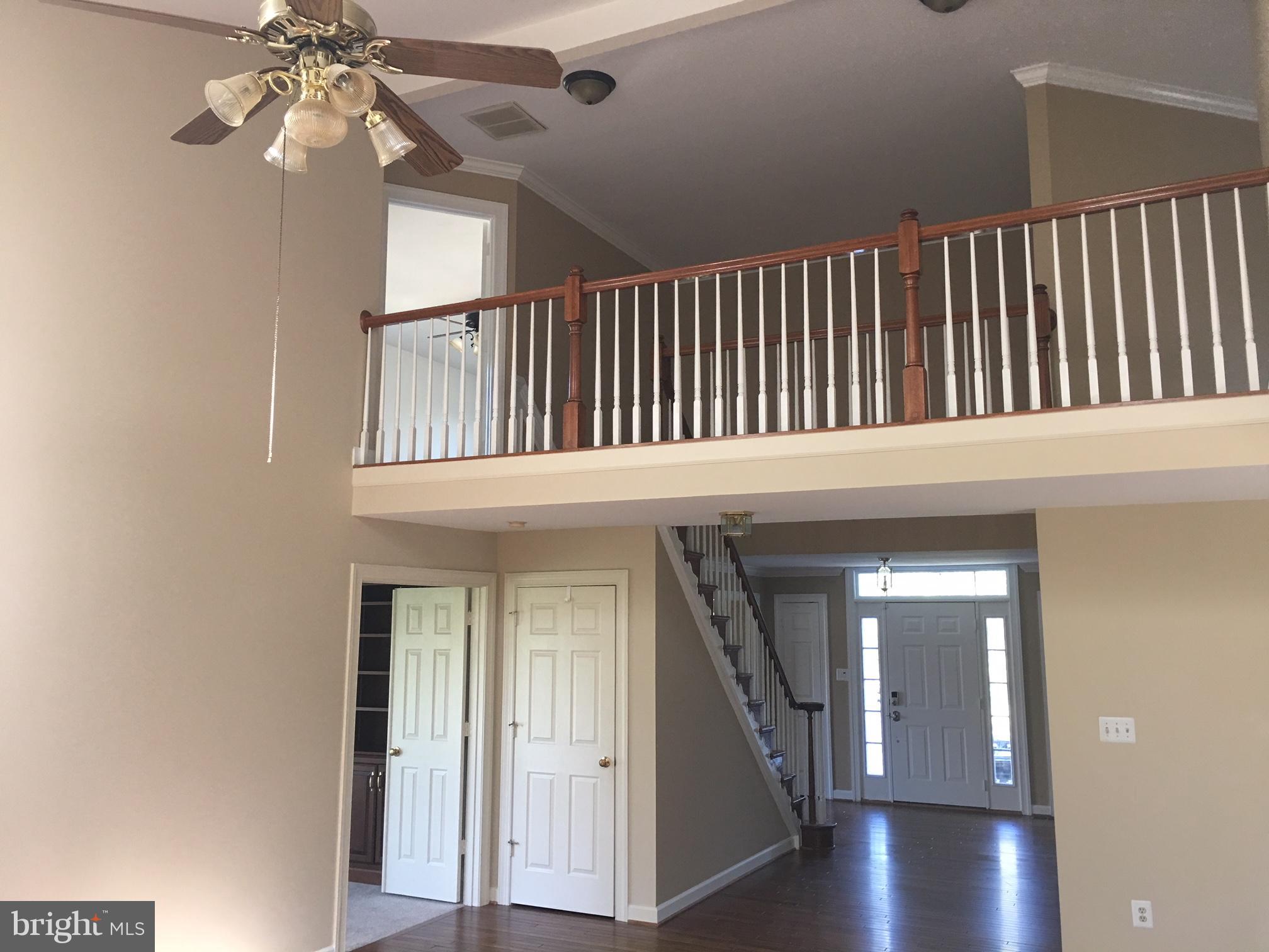 17106 Campbell Farm Road Poolesville, MD 20837 - Photo 11 of 30 a view of staircase with railing and a chandelier fan