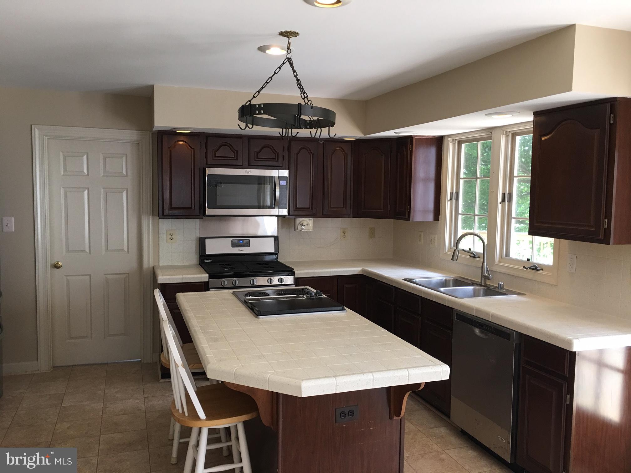 17106 Campbell Farm Road Poolesville, MD 20837 - Photo 14 of 30 a kitchen with a center island and cabinets