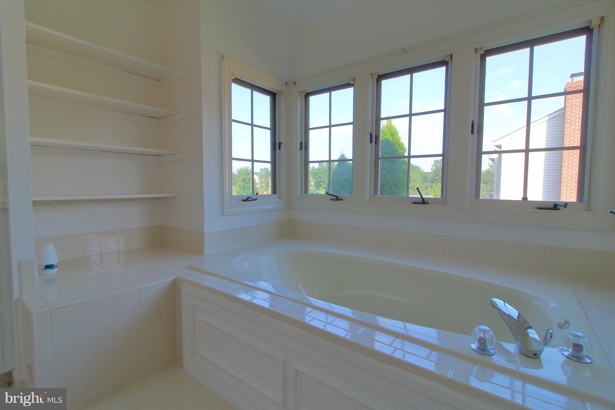 17106 Campbell Farm Road Poolesville, MD 20837 - Photo 21 of 30 a bathroom with a bathtub and next to a window