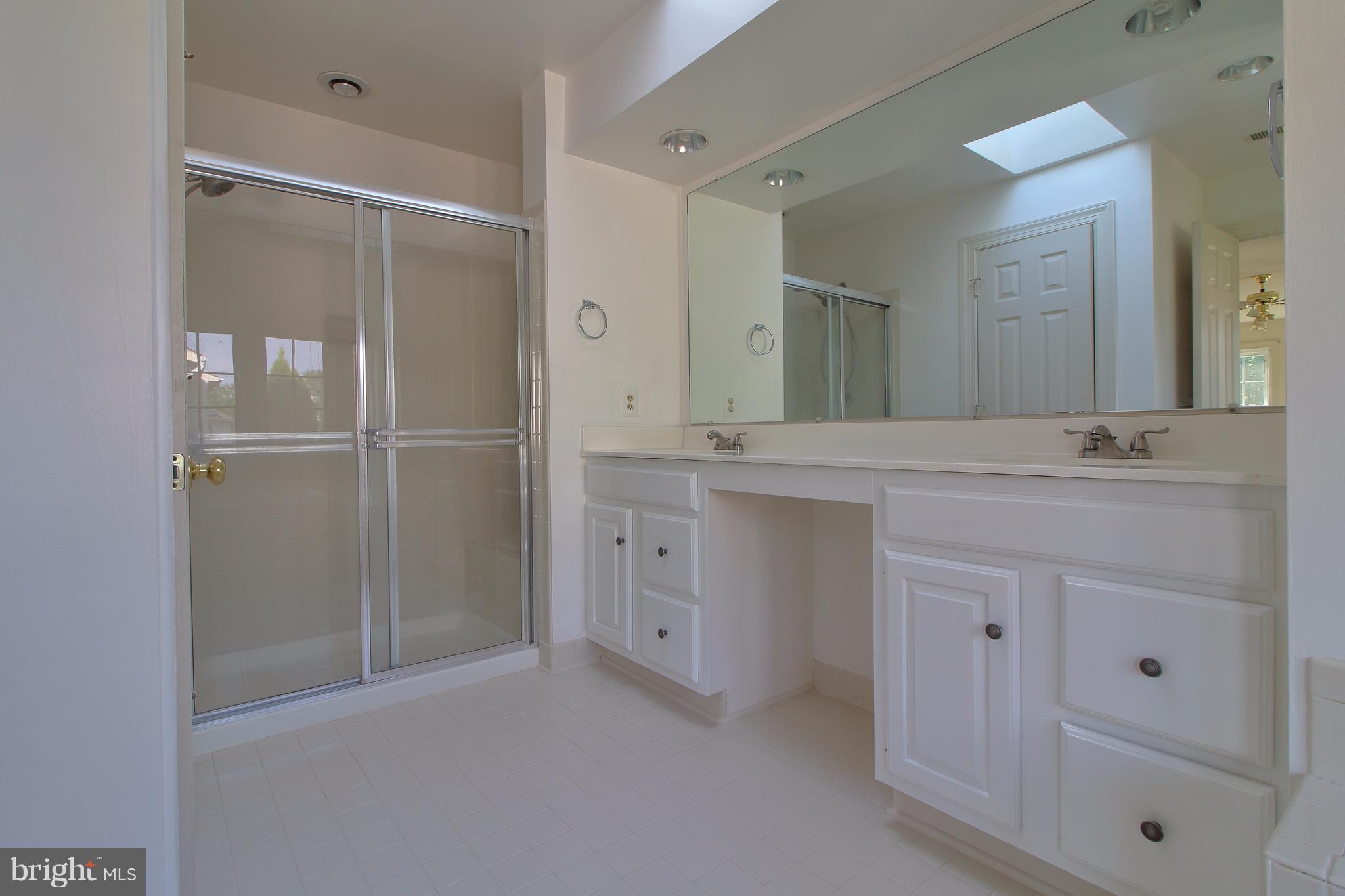 17106 Campbell Farm Road Poolesville, MD 20837 - Photo 22 of 30 a bathroom with a double vanity sink and mirror