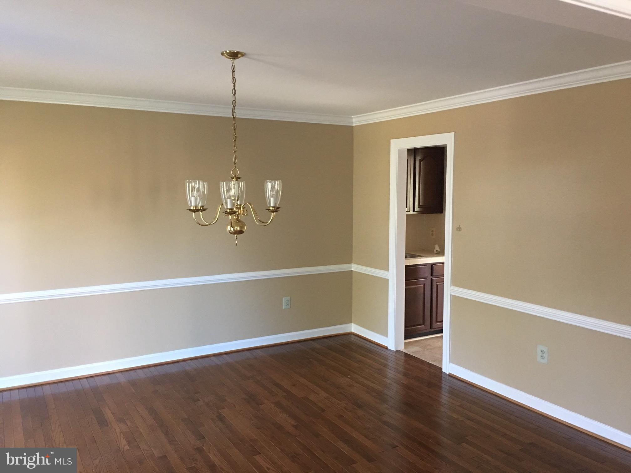 17106 Campbell Farm Road Poolesville, MD 20837 - Photo 8 of 30 a view of a room with wooden floor and a ceiling fan