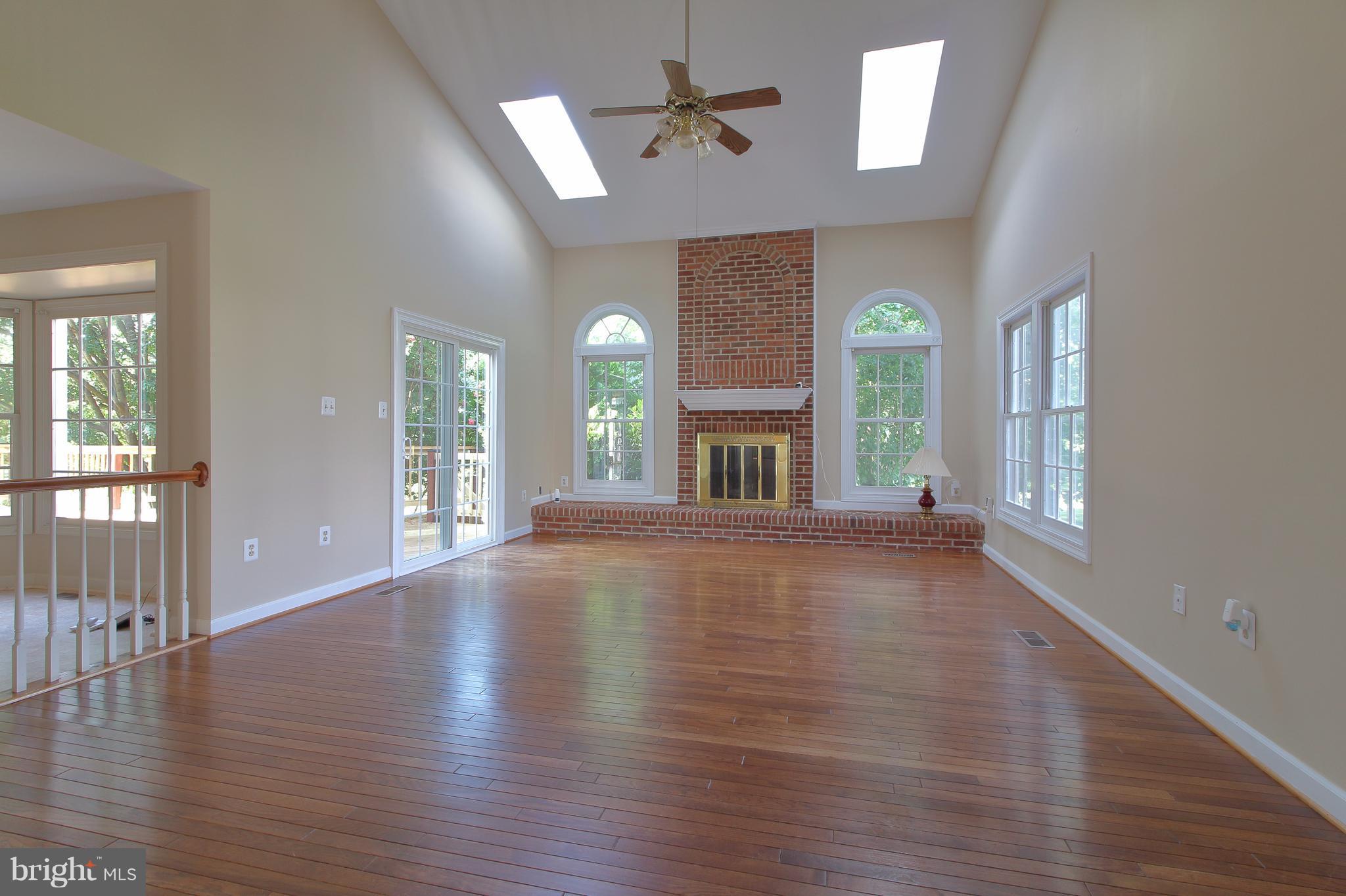 17106 Campbell Farm Road Poolesville, MD 20837 - Photo 9 of 30 an empty room with wooden floor and windows
