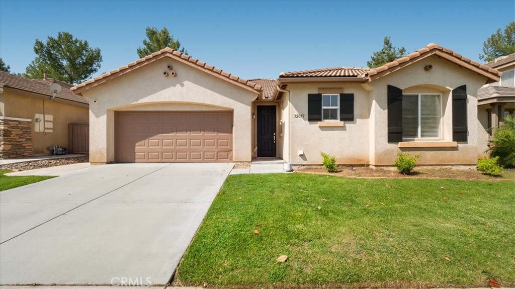 32059 Poppy Way Lake Elsinore, CA 92532 - Photo 1 of 1 a front view of a house with a yard