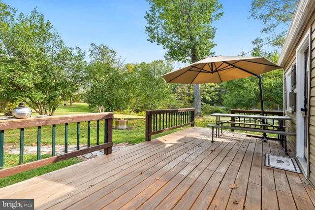 a view of balcony with wooden floor and outdoor seating