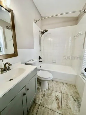a bathroom with a sink toilet a mirror and shower