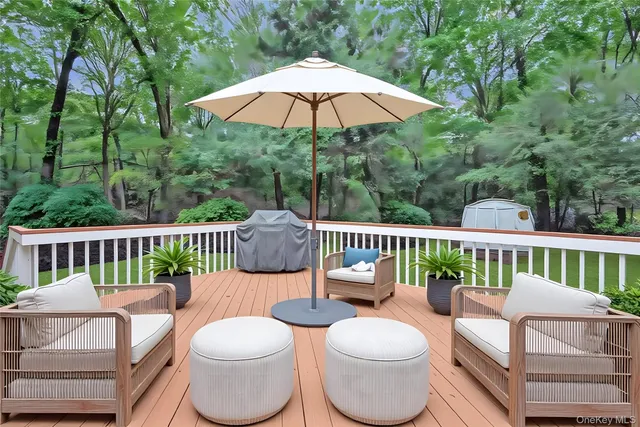 a view of a deck with furniture and a garden
