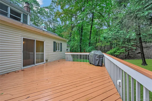 a balcony with wooden floor and fence