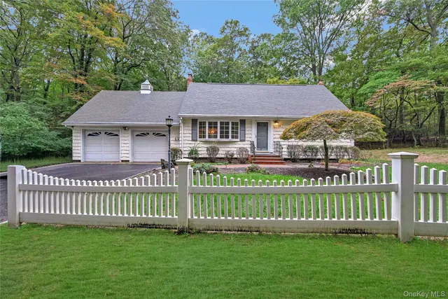 a front view of a house with a garden and deck