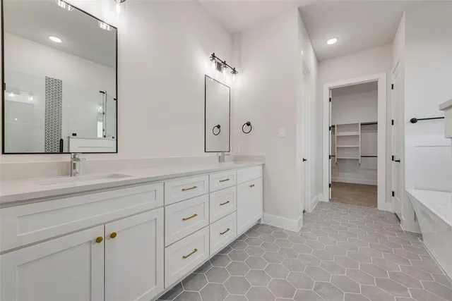a spacious bathroom with double sink and a mirror