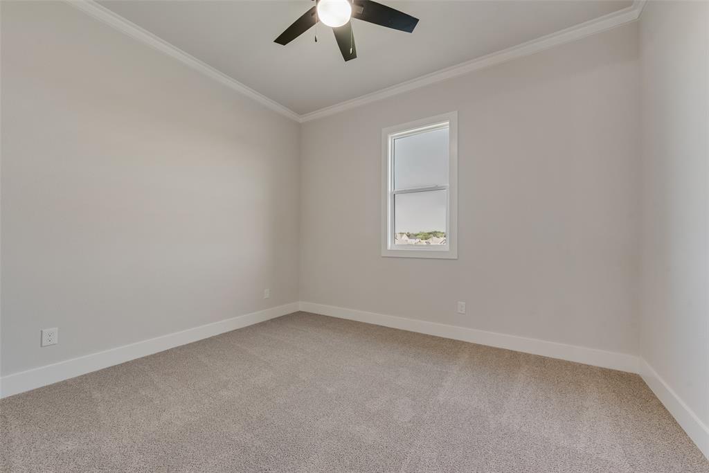 1342 Benjamin Trail Van Alstyne, TX 75495 - Photo 30 of 39 an empty room with a chandelier fan and windows