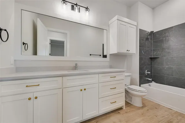 a bathroom with a double vanity sink a toilet and a mirror