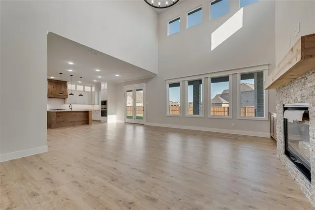 a view of empty room with wooden floor and fireplace