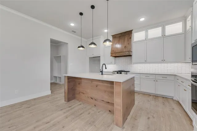 a kitchen with a sink appliances and cabinets