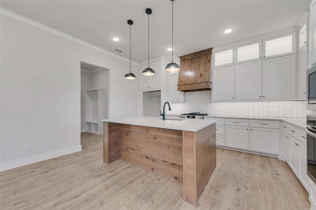 1342 Benjamin Trail Van Alstyne, TX 75495 - Photo 9 of 39 a kitchen with a sink appliances and cabinets