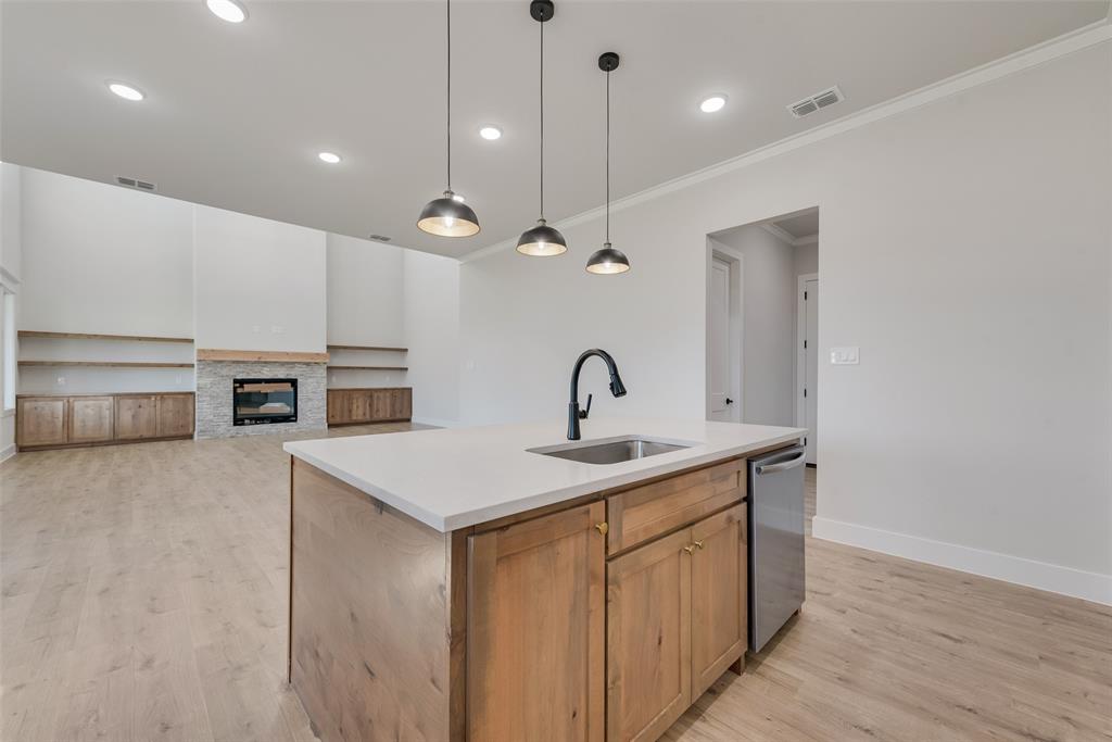 1342 Benjamin Trail Van Alstyne, TX 75495 - Photo 10 of 39 a kitchen with kitchen island a sink appliances and a counter top space