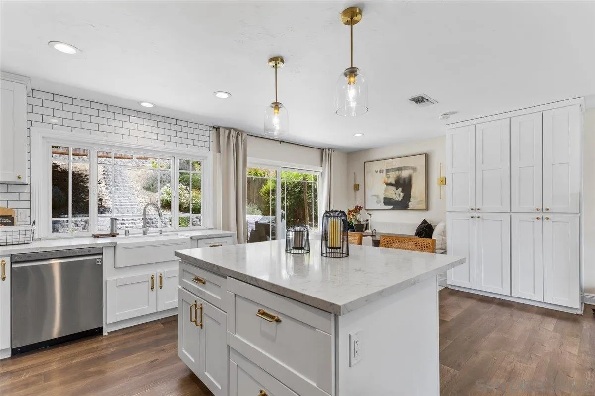 12243 Buckskin Trail Poway, CA 92064 - Photo 8 of 41 a open kitchen with stainless steel appliances granite countertop a sink a stove and a refrigerator