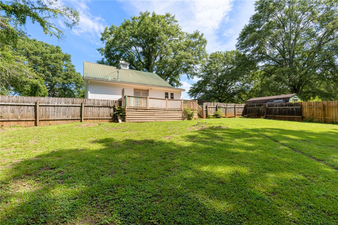 108 Tarrant Street Central, SC 29630 - Photo 34 of 42 A spacious, fenced backyard offers a wooden deck for outdoor enjoyment.