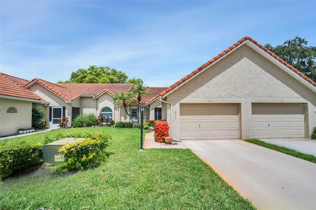 a front view of house with yard and garage