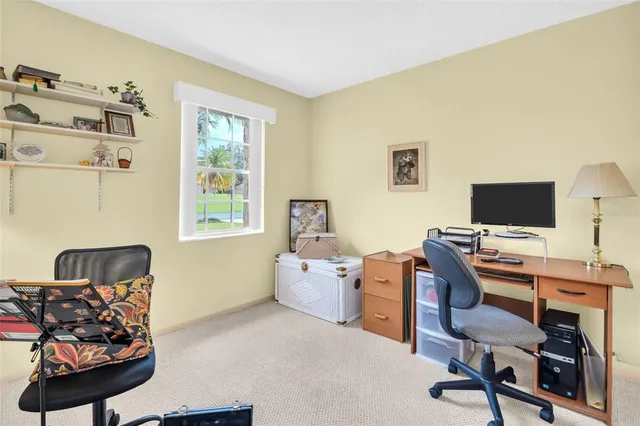 a view of a workspace with furniture and a window