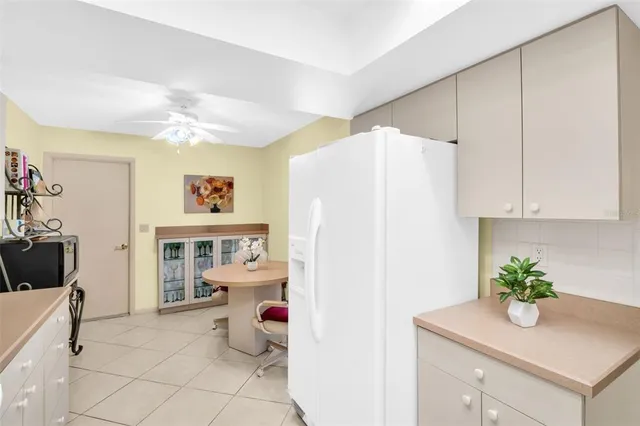 a kitchen with stainless steel appliances cabinets and a window