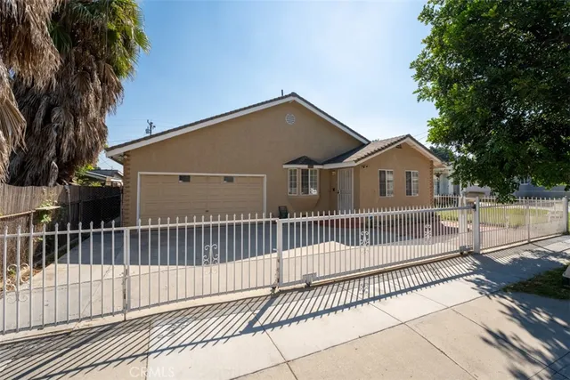 a view of a house with a wooden fence
