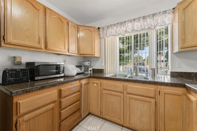 a kitchen with granite countertop white cabinets and white appliances