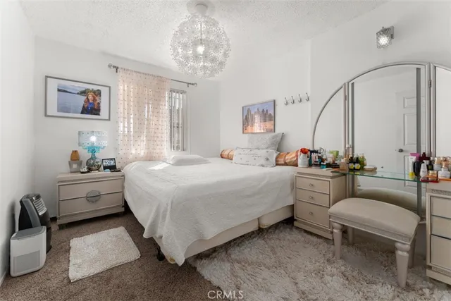 a bed room with furniture and a chandelier
