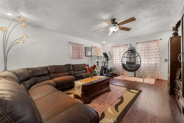 a living room with furniture a clock and a flat screen tv