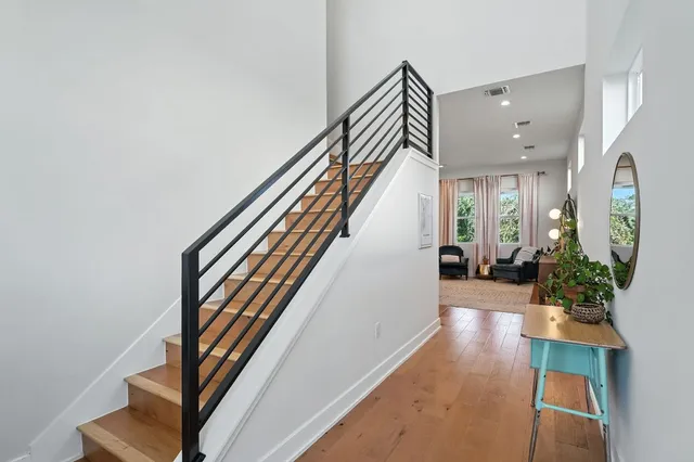 a view of entryway and hall with wooden floor