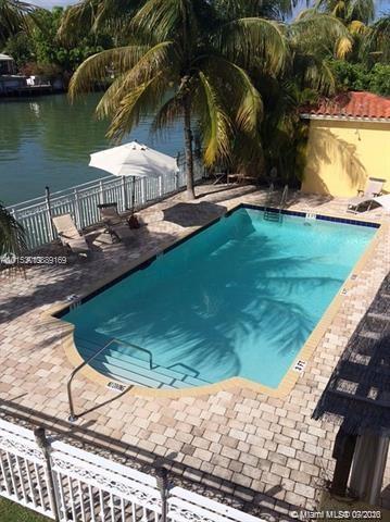 4812 Pine Tree Drive, Unit 203 Miami Beach, FL 33140 - Photo 2 of 19 a view of swimming pool with lawn chairs and plants