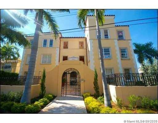 4812 Pine Tree Drive, Unit 203 Miami Beach, FL 33140 - Photo 16 of 19 a view of a brick house with many windows next to a yard