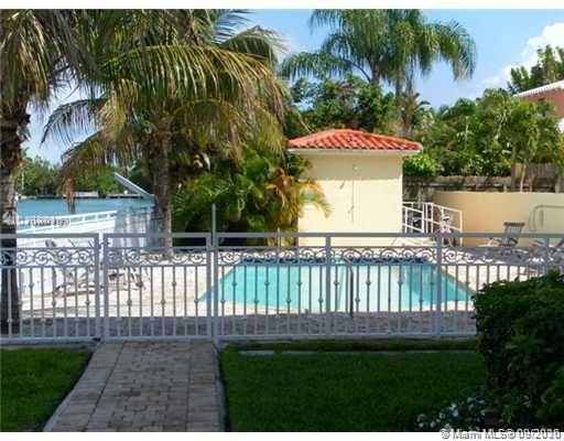 4812 Pine Tree Drive, Unit 203 Miami Beach, FL 33140 - Photo 18 of 19 a view of backyard with a garden and trees