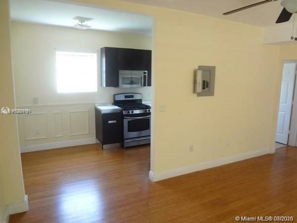 4812 Pine Tree Drive, Unit 203 Miami Beach, FL 33140 - Photo 5 of 19 a kitchen with stainless steel appliances a refrigerator and a stove top oven