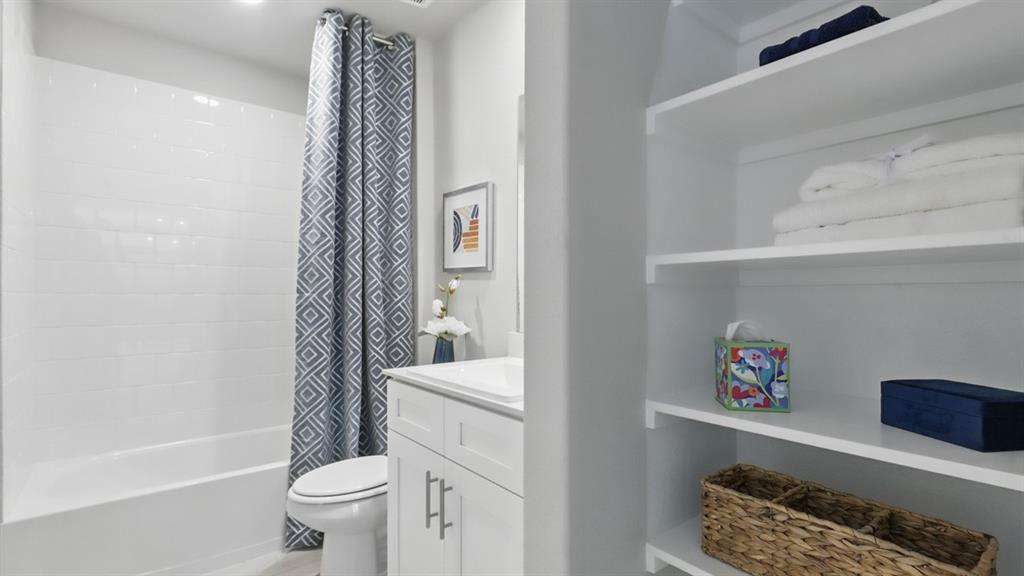 1636 Tin Roof Road Krum, TX 76249 - Photo 27 of 35 a bathroom with a toilet a sink and bathtub